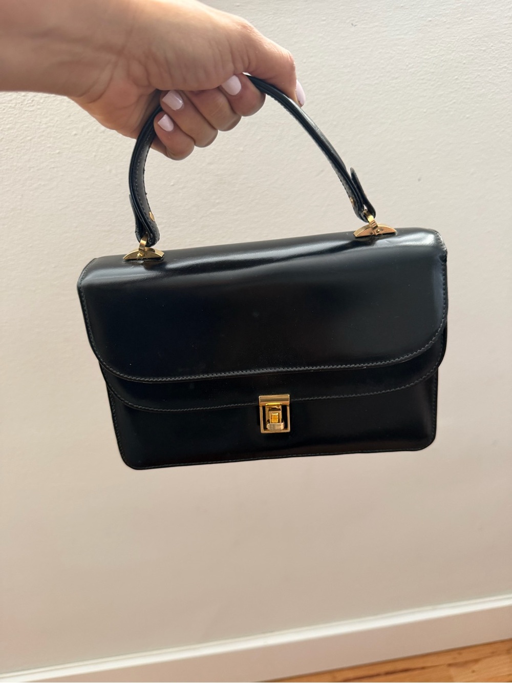 Elegantly Structured Black Top-Handle Mini Bag with Gold Hardware